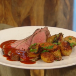Matt Tebbutt butterflied leg of lamb with garlic dressing, smoked onions, caraway roasted potatoes and barbecue gravy recipe on Saturday Kitchen