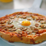 Nadiya Hussain breakfast pizza with  tomato ketchup, beans, mushrooms, sausages and eggs recipe on Nadiya’s Everyday Baking