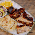 Ainsley Harriott jerk pork belly with roti and coconut and mango slaw recipe on Ainsley’s Food We Love
